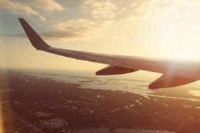 Plane wing shimmering in the light of a sunset.