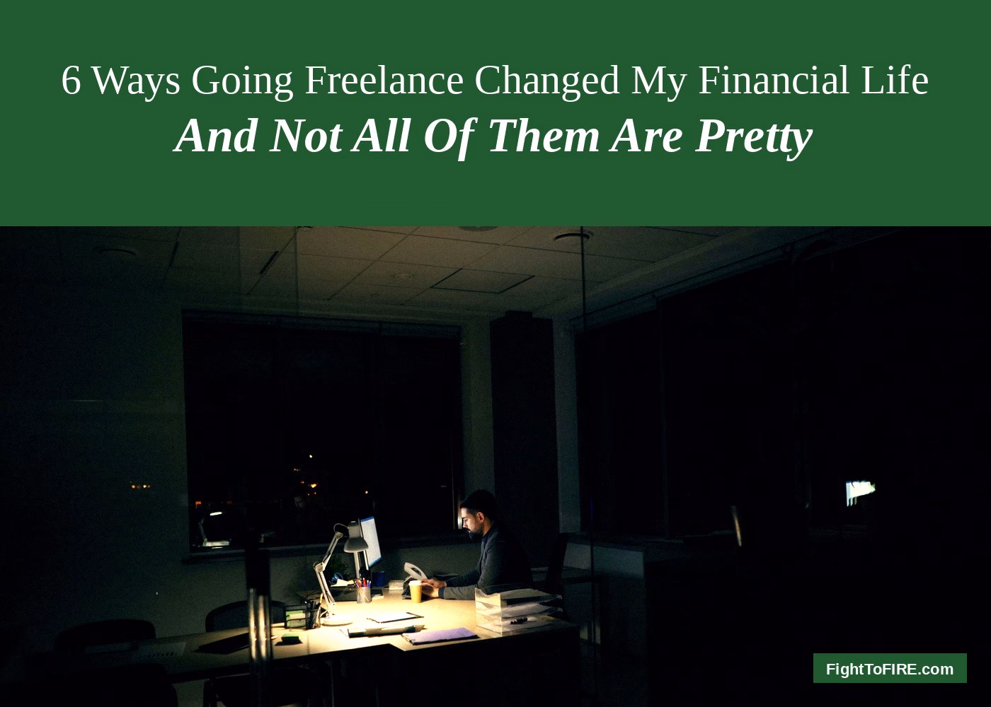 Man working alone at a lit desk in a dark office — going freelance in Belgium